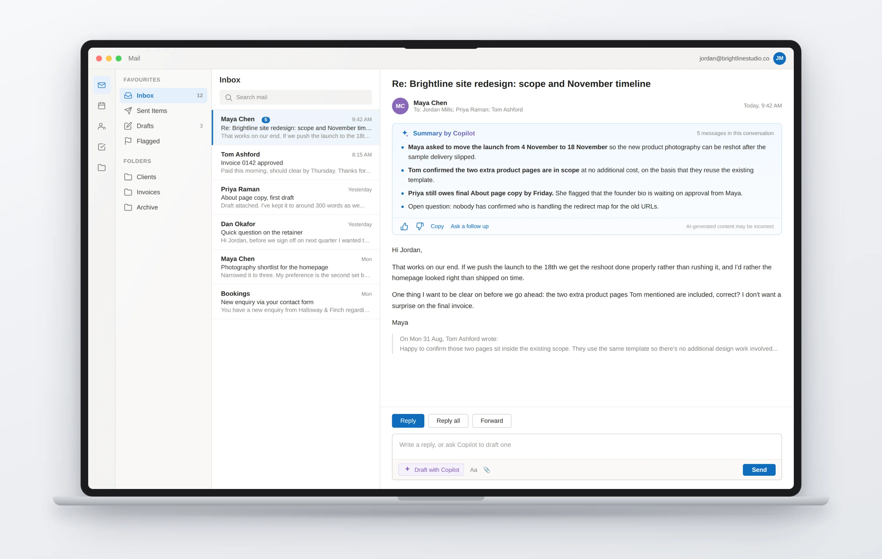 A laptop showing an email client with a Copilot summary card at the top of an open thread, above the message itself.